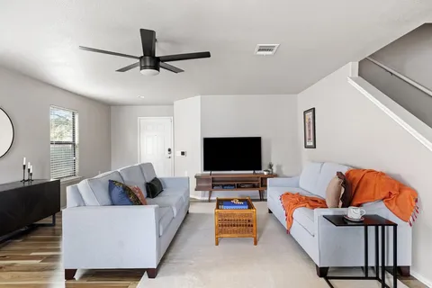 a living room with furniture and a flat screen tv