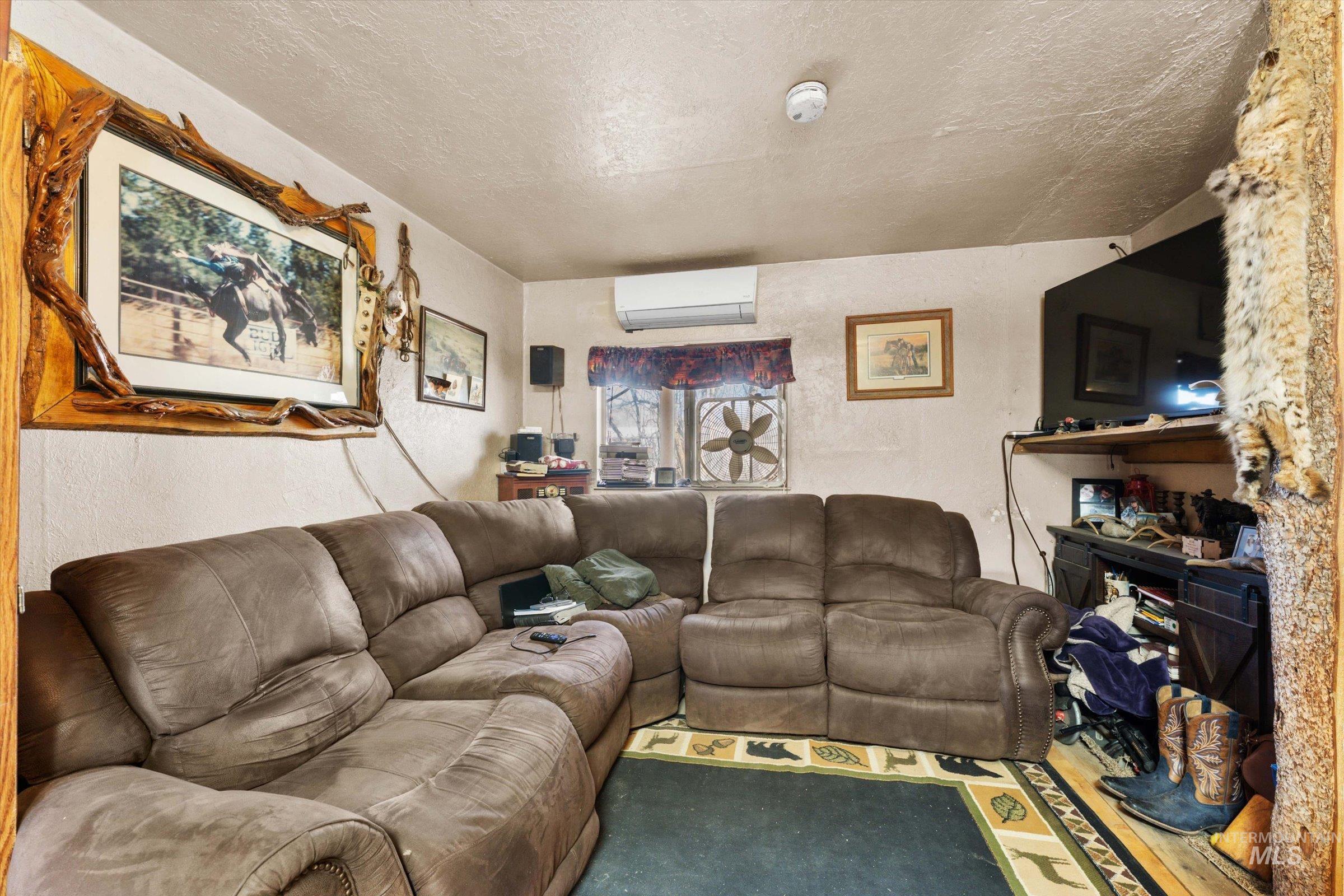 11555 Liberty Road Sweet, ID 83670 - Photo 31 of 49 Living room featuring a textured ceiling, a mini split for heating / cooling, and a textured wall