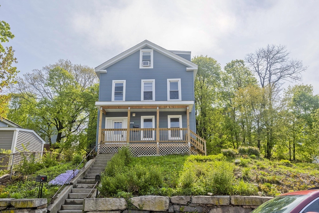 107 Eastern Avenue Worcester, MA 01605 - Photo 1 of 38 a front view of a house with a yard