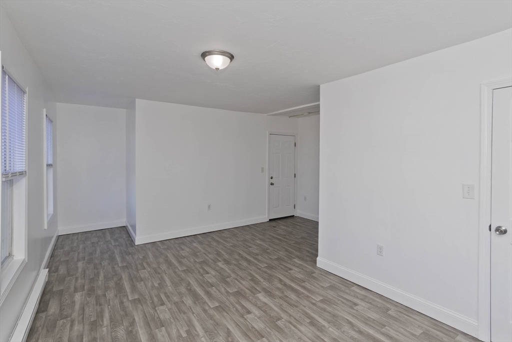 107 Eastern Avenue Worcester, MA 01605 - Photo 11 of 38 a view of an empty room with wooden floor