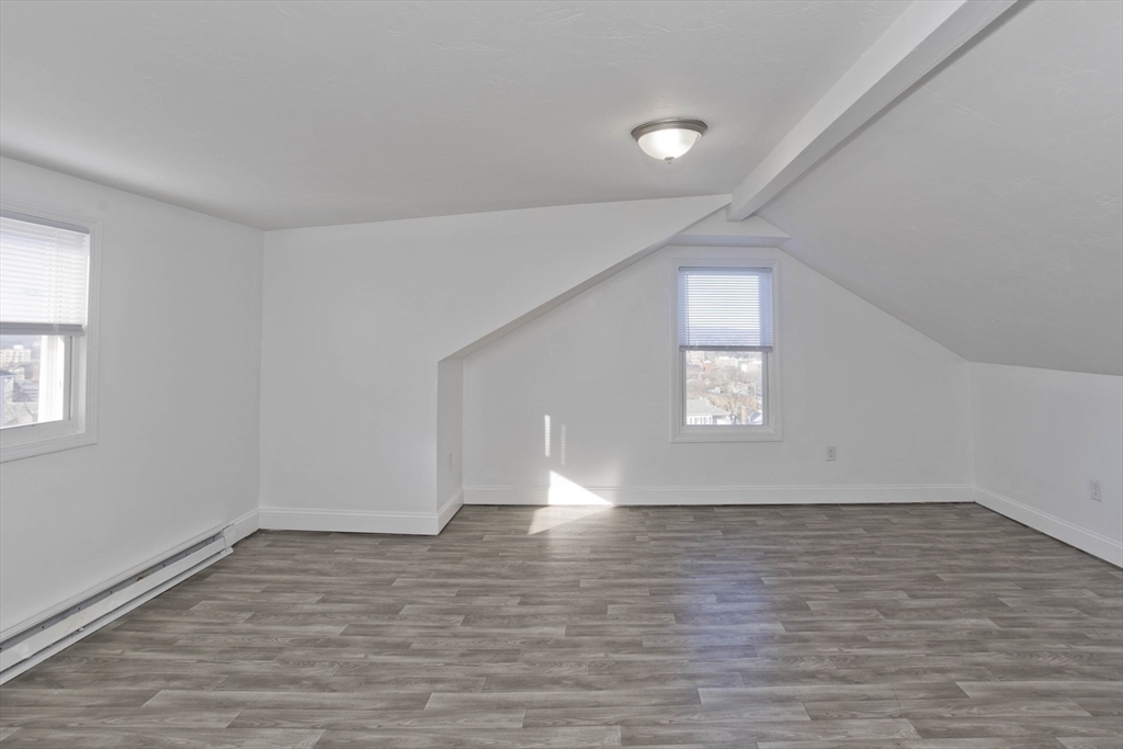 107 Eastern Avenue Worcester, MA 01605 - Photo 13 of 38 wooden floor in an empty room with a window