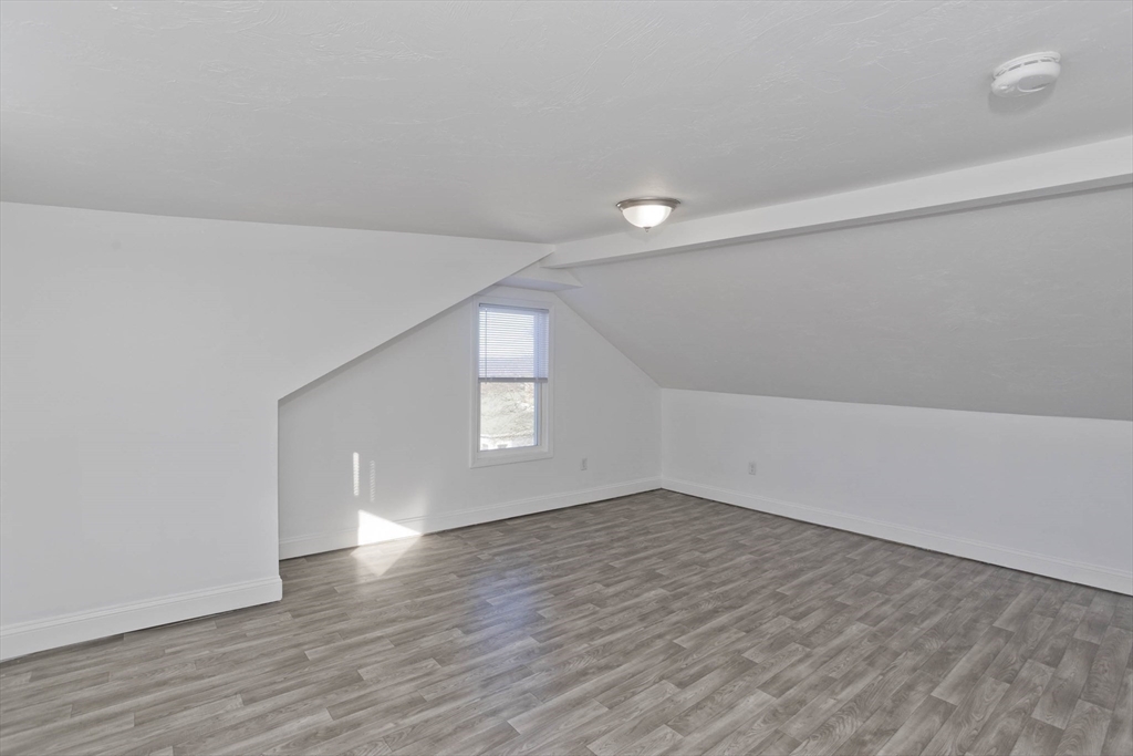 107 Eastern Avenue Worcester, MA 01605 - Photo 14 of 38 wooden floor in an empty room with a window