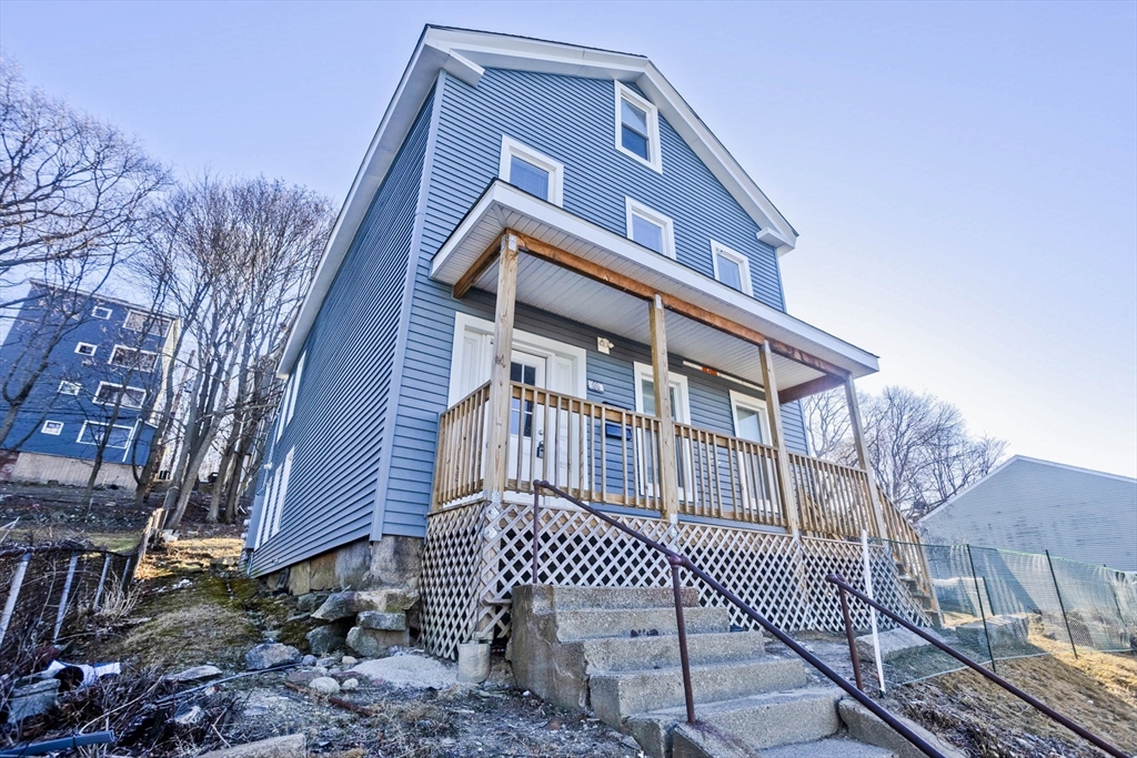 107 Eastern Avenue Worcester, MA 01605 - Photo 2 of 38 a front view of a house with a yard