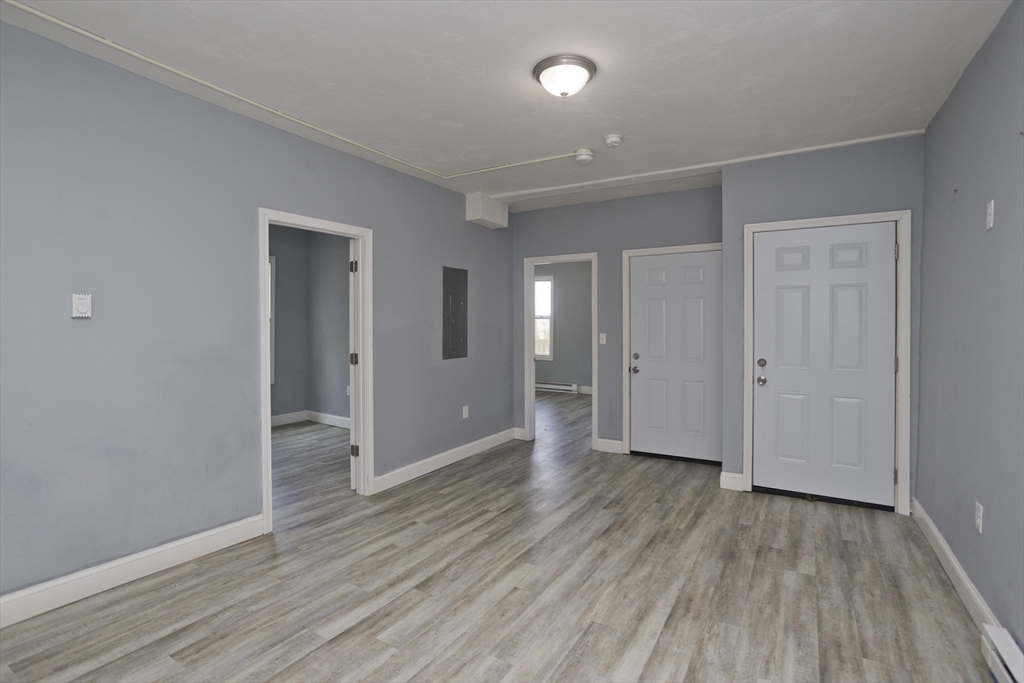 107 Eastern Avenue Worcester, MA 01605 - Photo 25 of 38 wooden floor with white walls