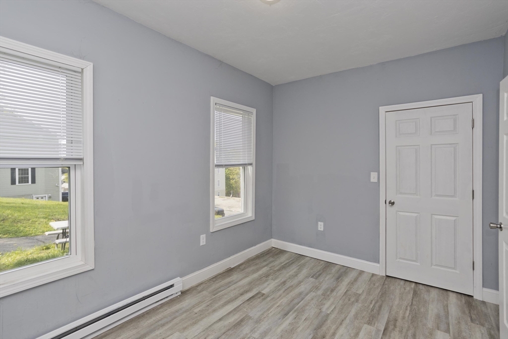 107 Eastern Avenue Worcester, MA 01605 - Photo 31 of 38 wooden floor in an empty room with a window