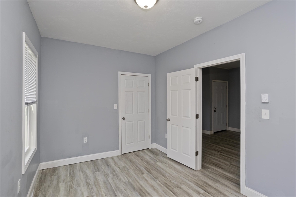 107 Eastern Avenue Worcester, MA 01605 - Photo 32 of 38 a view of a hallway with wooden floor