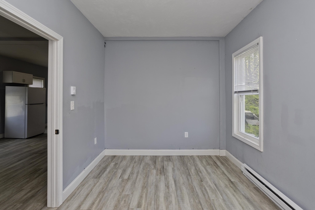 107 Eastern Avenue Worcester, MA 01605 - Photo 34 of 38 wooden floor in an empty room with a window