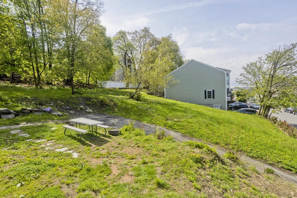 107 Eastern Avenue Worcester, MA 01605 - Photo 37 of 38 a view of house with backyard and trees