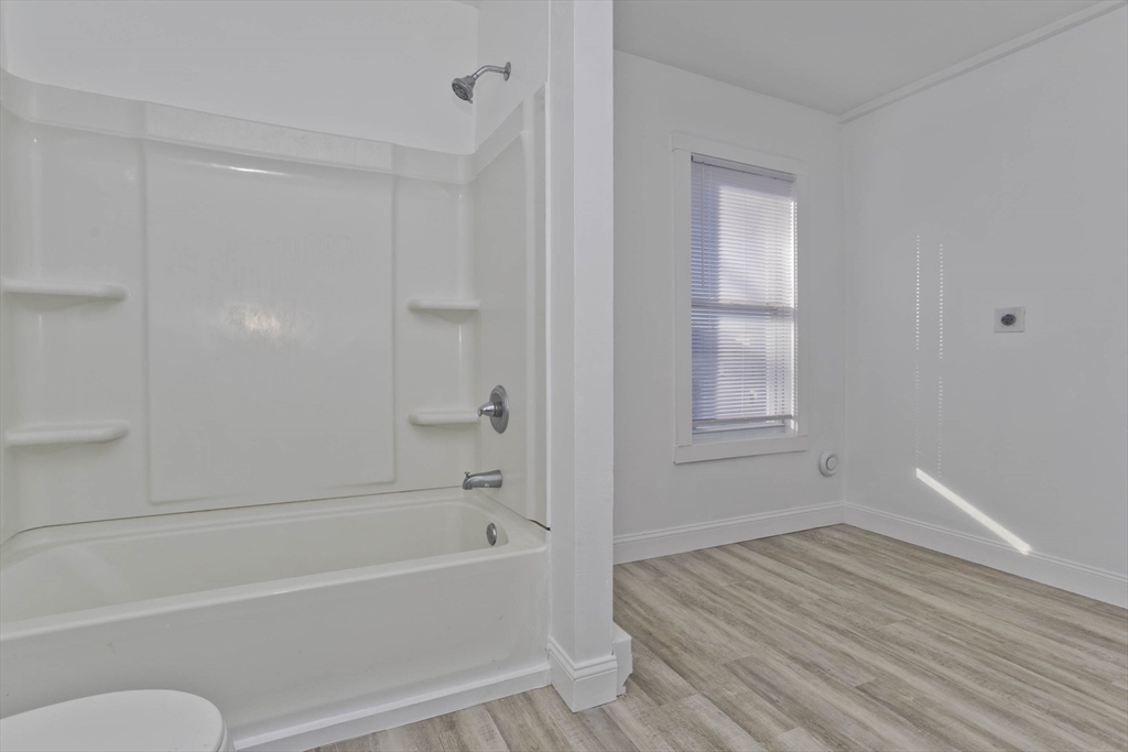 107 Eastern Avenue Worcester, MA 01605 - Photo 8 of 38 a bathroom with a bathtub and a shower