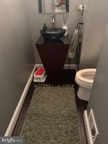 a bathroom with a toilet and a mirror