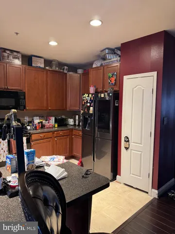 a kitchen with granite countertop lots of appliances and cabinets