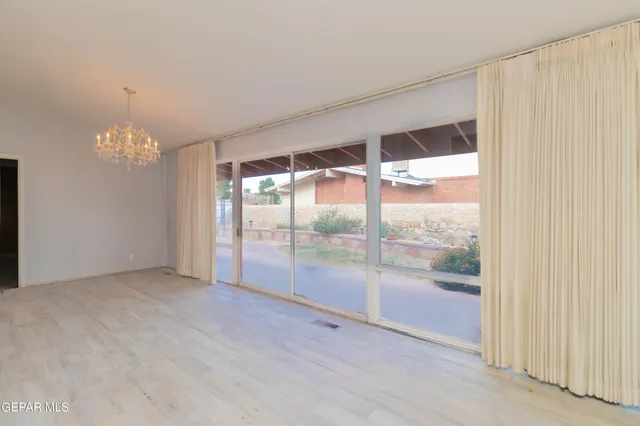 a view of an empty room with glass door