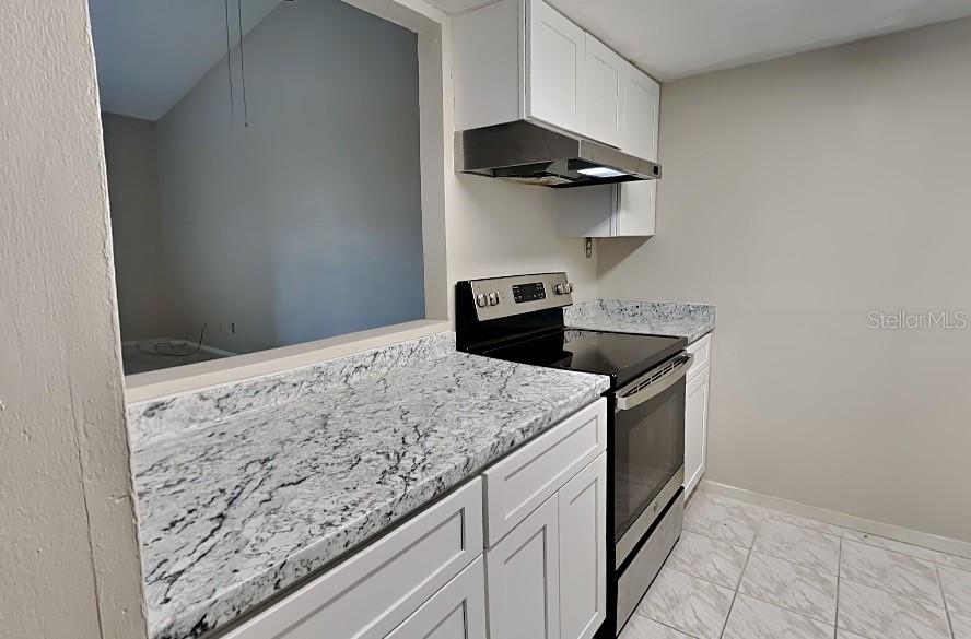 1921 Truman Road Orlando, FL 32807 - Photo 3 of 19 a kitchen with a stove and a refrigerator