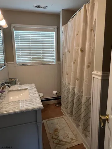 a bathroom with a sink and a window