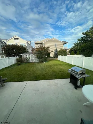 a backyard of a house with table and chairs