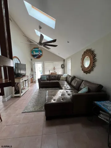 a living room with furniture and a clock