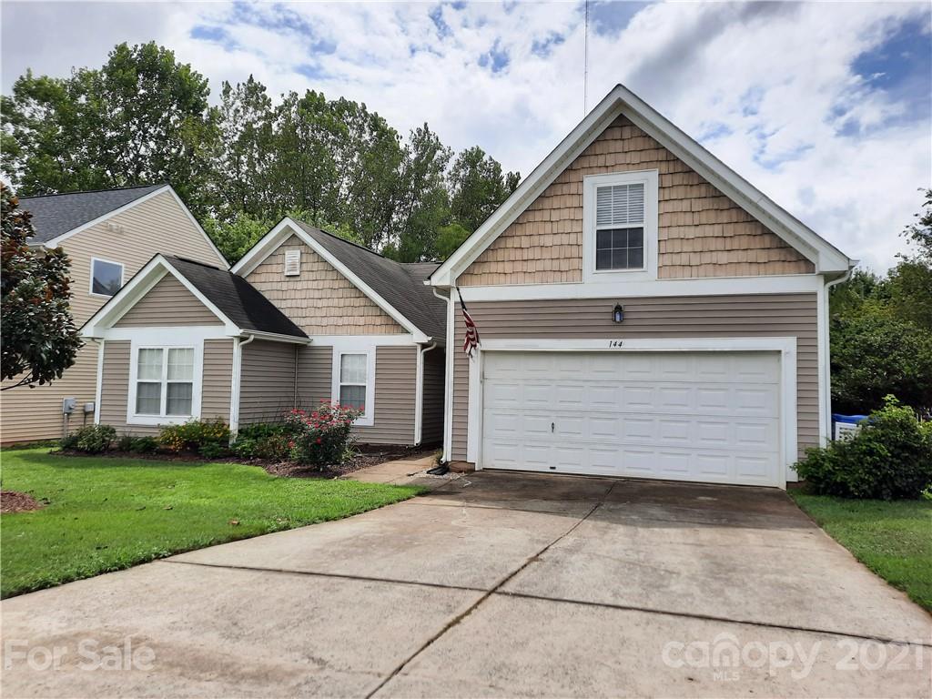 144 Bluffton Road Mooresville, NC 28115 - Photo 1 of 16 a front view of a house with a yard and garage