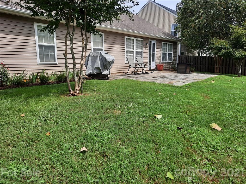 144 Bluffton Road Mooresville, NC 28115 - Photo 2 of 16 a front view of a house with a yard patio and fire pit