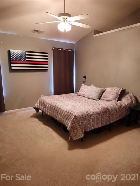 144 Bluffton Road Mooresville, NC 28115 - Photo 13 of 16 a bedroom with a bed and a ceiling fan