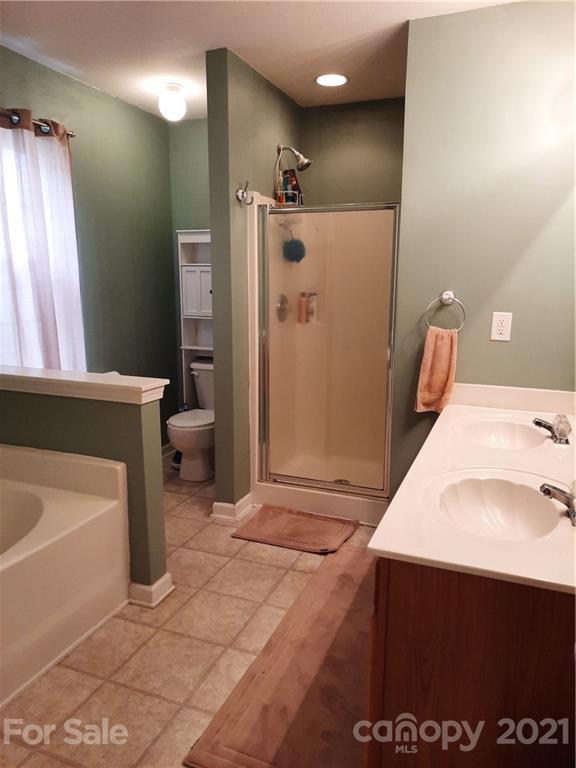 144 Bluffton Road Mooresville, NC 28115 - Photo 14 of 16 a bathroom with a sink a toilet and shower