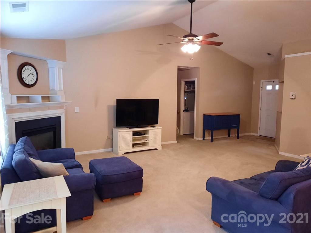 144 Bluffton Road Mooresville, NC 28115 - Photo 4 of 16 a living room with furniture and a flat screen tv