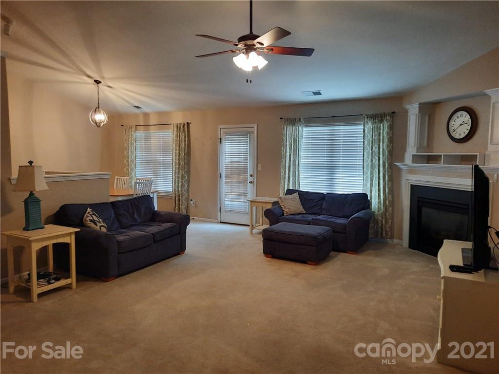 144 Bluffton Road Mooresville, NC 28115 - Photo 5 of 16 a living room with furniture and a fireplace