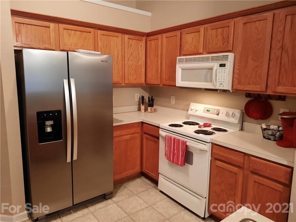 144 Bluffton Road Mooresville, NC 28115 - Photo 6 of 16 a kitchen with stainless steel appliances granite countertop a refrigerator stove and sink