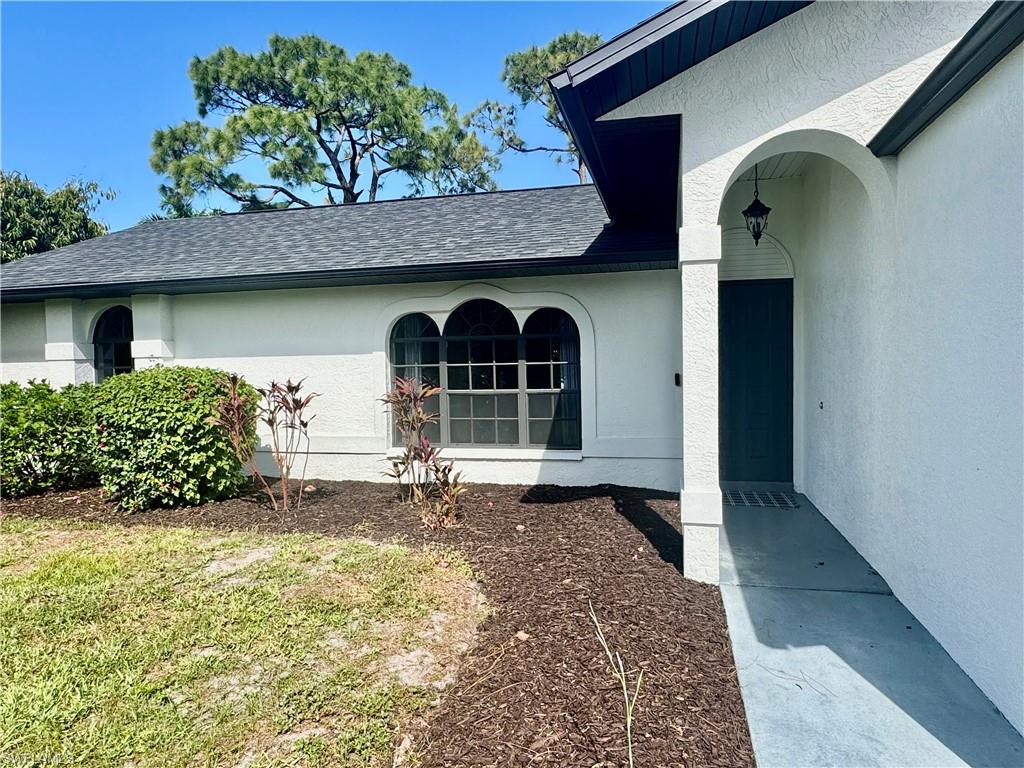 8137 Pelican Road Fort Myers, FL 33967 - Photo 2 of 21 a front view of a house with garden