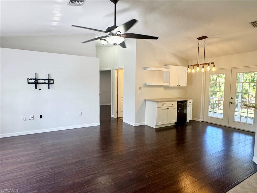 8137 Pelican Road Fort Myers, FL 33967 - Photo 4 of 21 a view of an empty room with a window and wooden floor