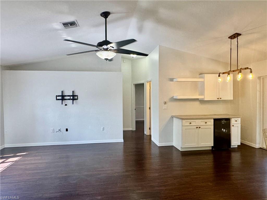 8137 Pelican Road Fort Myers, FL 33967 - Photo 5 of 21 wooden floor with white cabinets and wooden floor