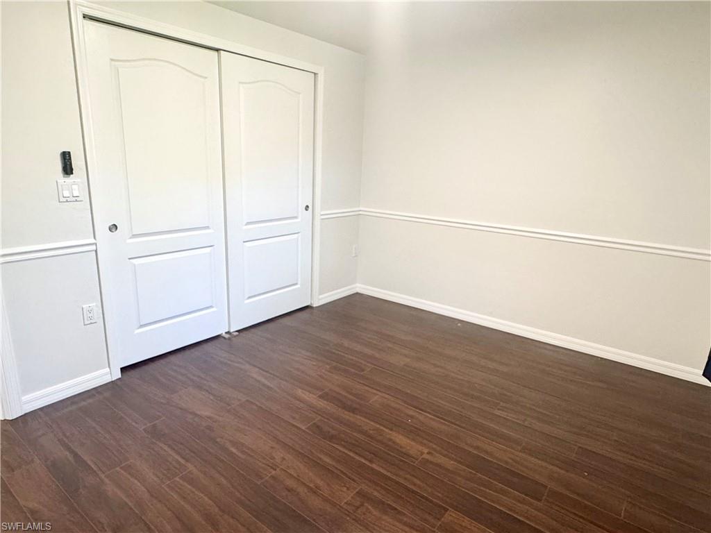 8137 Pelican Road Fort Myers, FL 33967 - Photo 10 of 21 an empty room with wooden floor