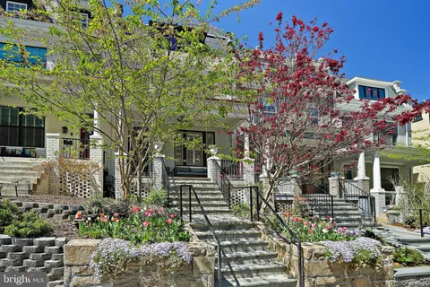 a front view of a multi story residential apartment building with a yard