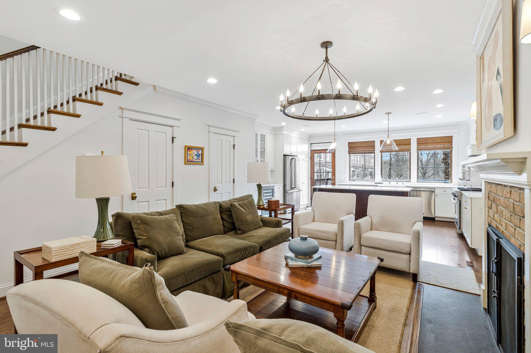 2916 18th Street Northwest Washington, DC 20009 - Photo 49 of 49 a living room with furniture a fireplace and a chandelier