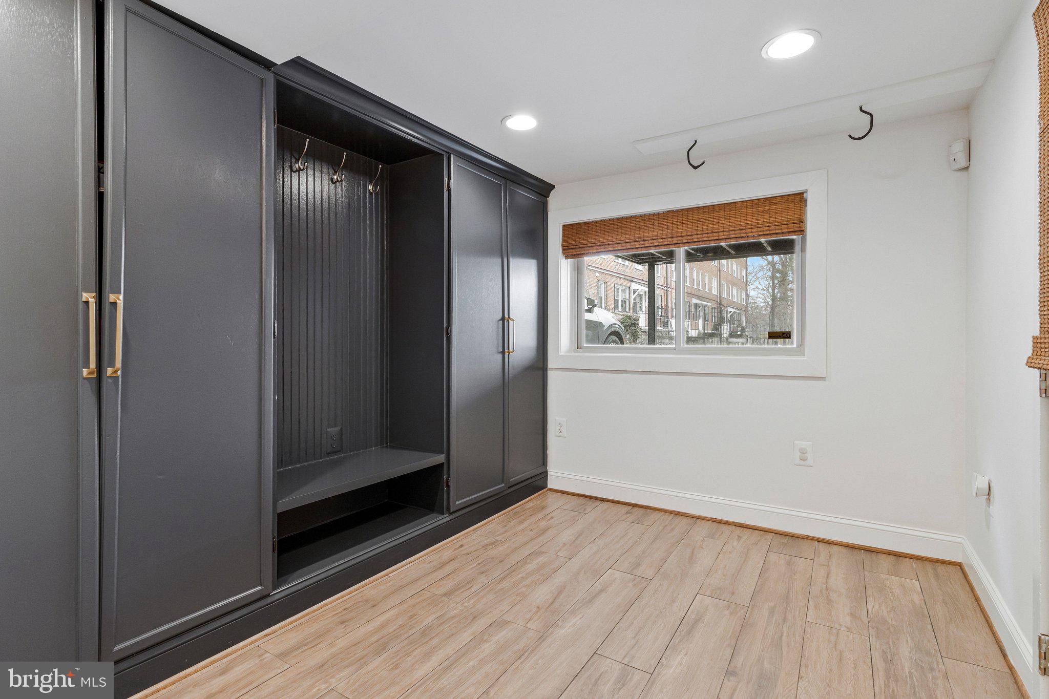 2916 18th Street Northwest Washington, DC 20009 - Photo 42 of 49 an empty room with wooden floor closet and windows