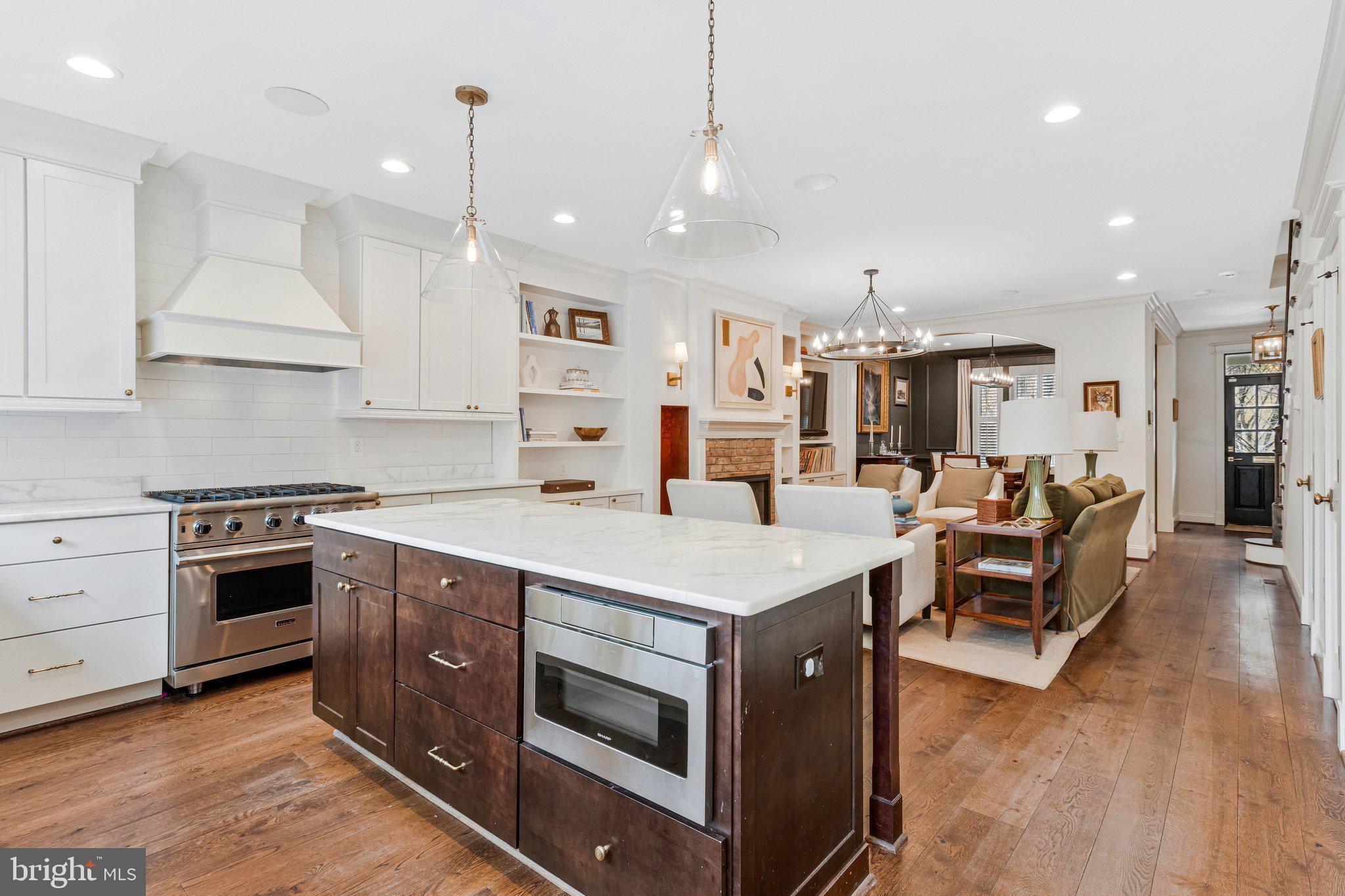 2916 18th Street Northwest Washington, DC 20009 - Photo 9 of 49 a large kitchen with stainless steel appliances and white cabinets