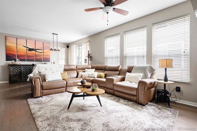 a living room with furniture a fireplace and a window