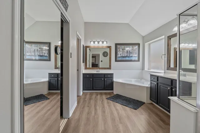 a large bathroom with a tub and shower