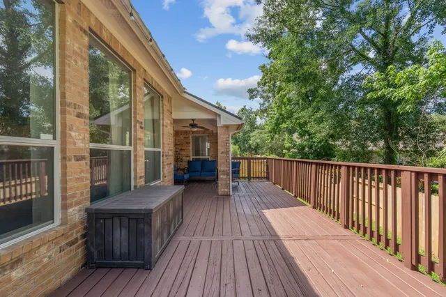 a view of balcony with wooden floor and fence