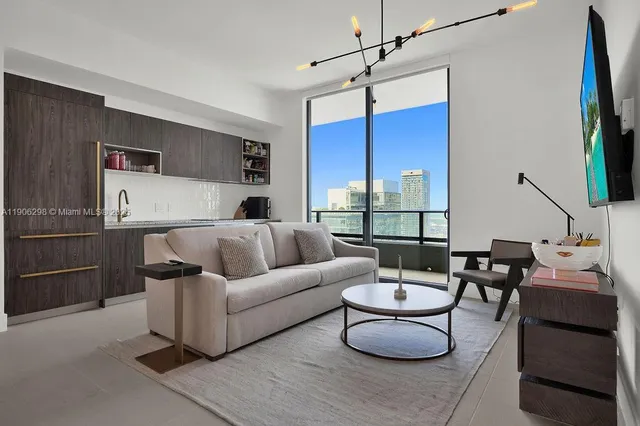 a living room with furniture a table and a flat screen tv