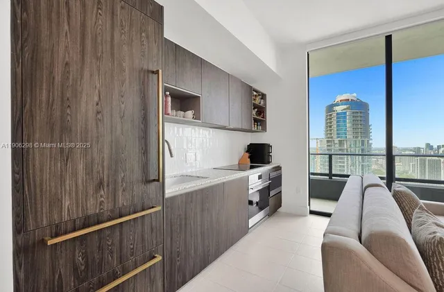 a view of a living room with furniture and a window