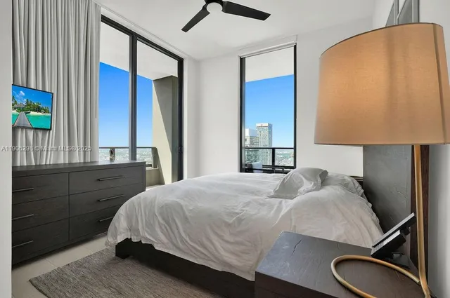 a bedroom with a bed lamp and a dresser