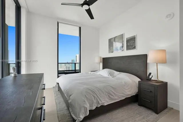 a bedroom with a bed and a night stand