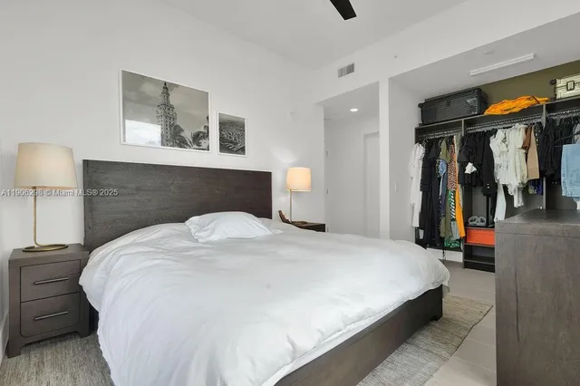 a bedroom with a bed and lamp