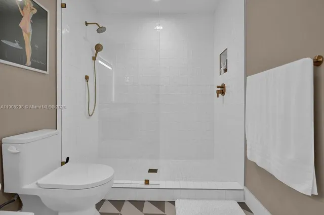 a bathroom with a shower a toilet and a shower