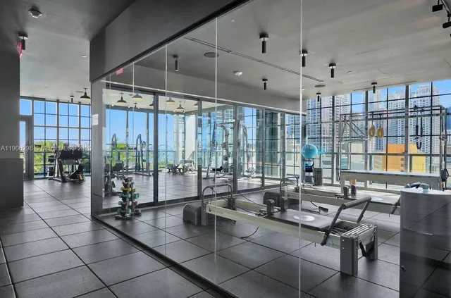 a very nice looking room with a large window and wooden floor