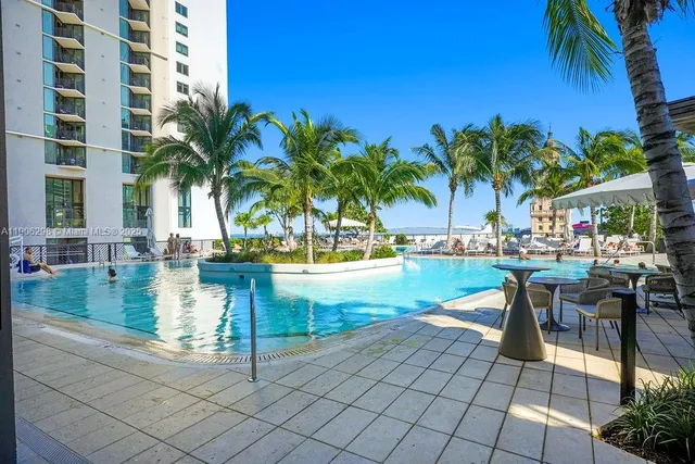 a view of swimming pool with outdoor seating and plants