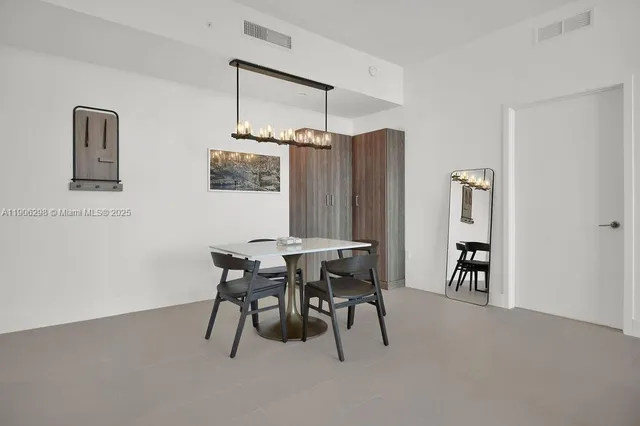 a dining room with furniture and window