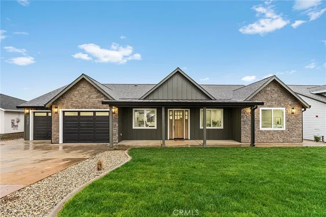a front view of a house with a yard and garage