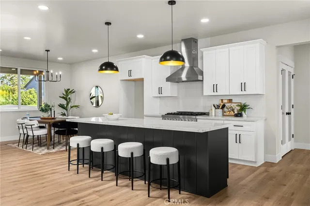 a kitchen with a dining table chairs sink and cabinets
