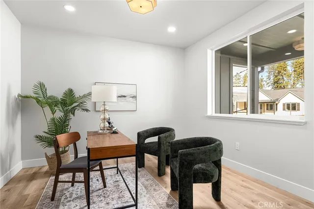 a dining room with furniture and a potted plant
